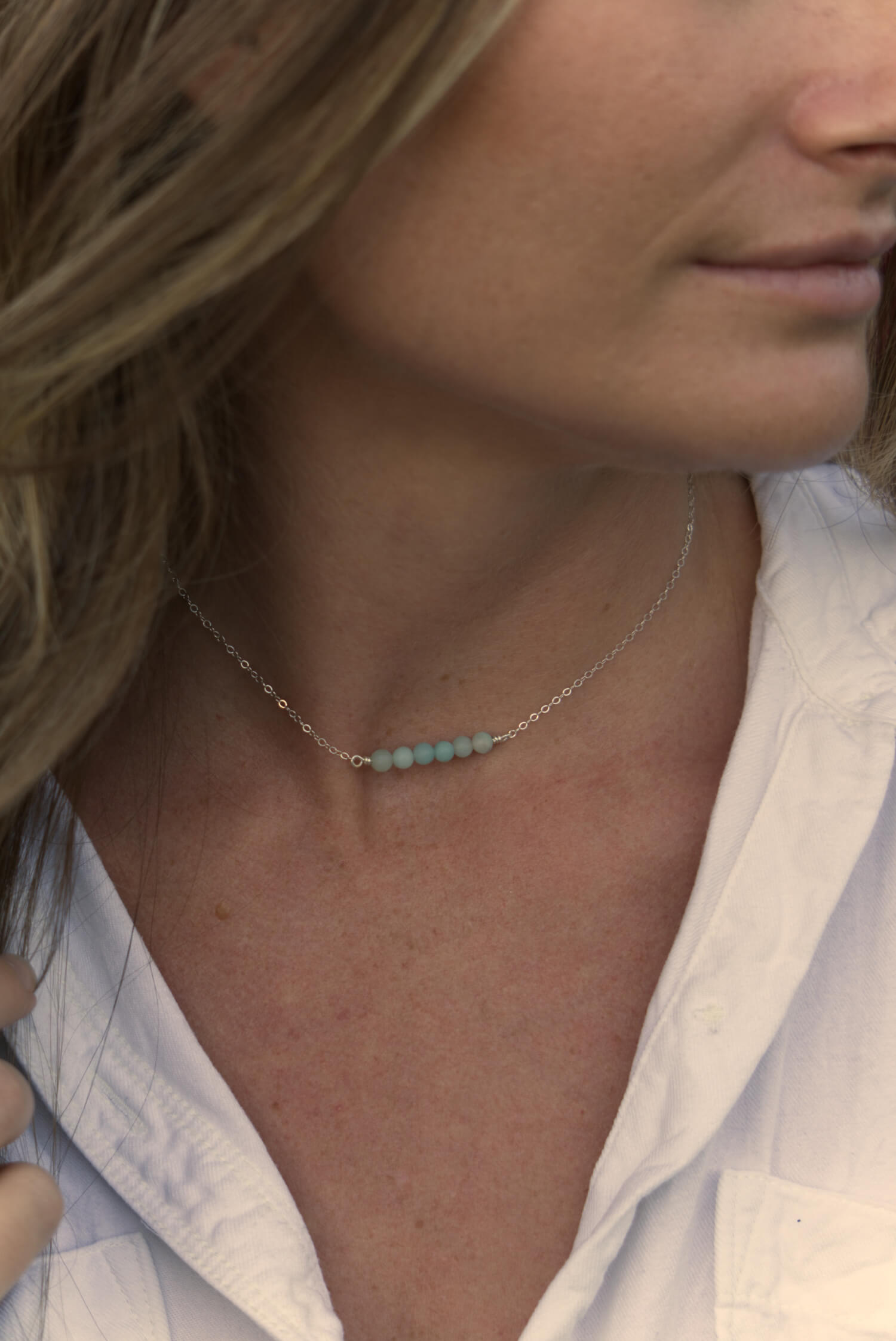 girl wearing a silver chain necklace with amazonite beads