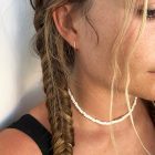 small gold hoop and white beaded choker on a girl with fishtail braids