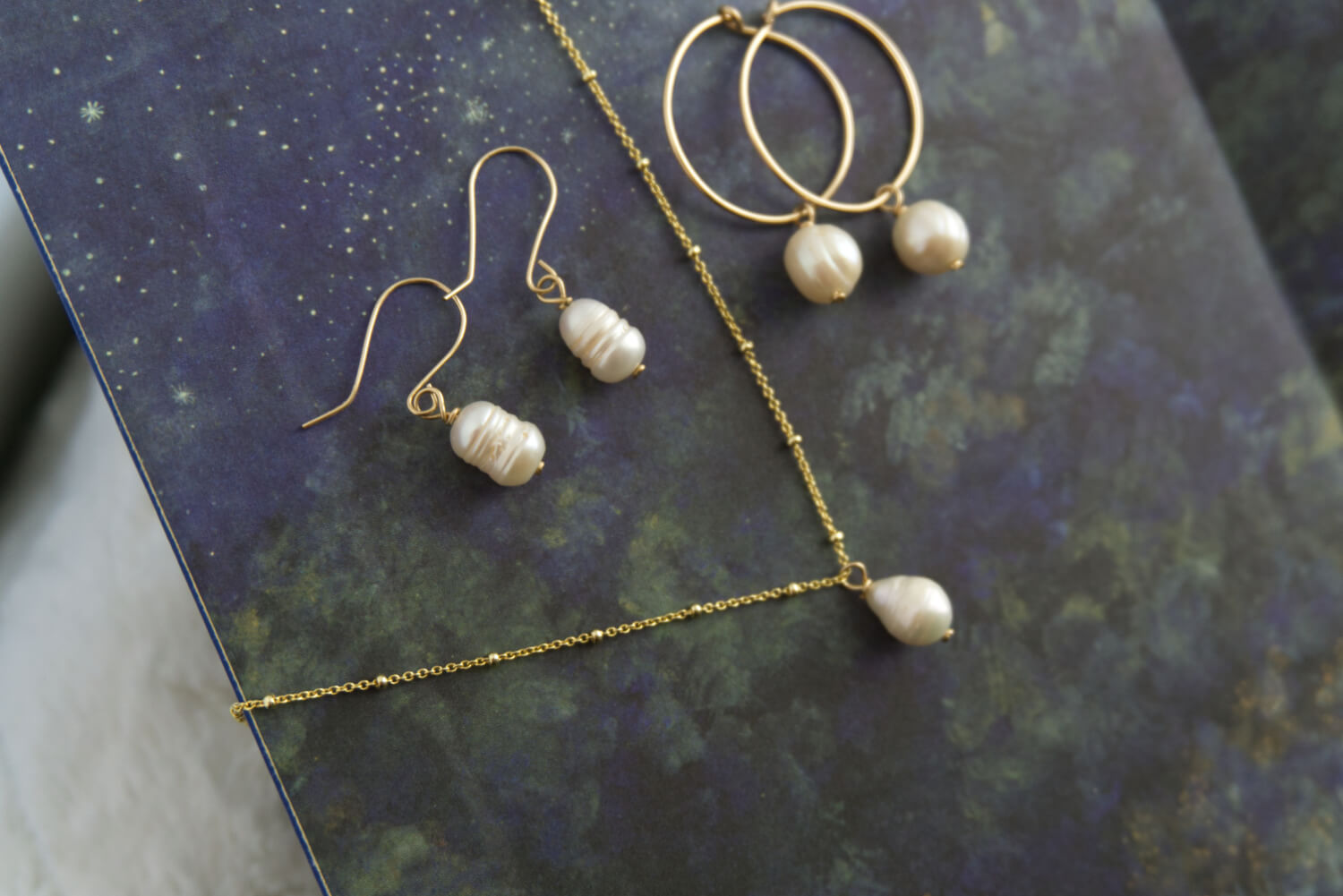 pearl necklace with a gold satellite chain, pearl dangle earrings, pearls on gold hoops